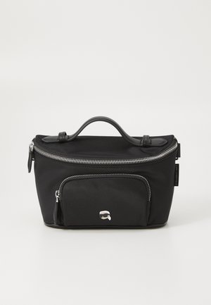 Black nylon bag with a top handle, silver zipper closure, front zipper pocket, and a small logo detail on the front. Smooth texture.