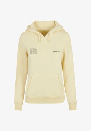 Sudadera color crema con bolsillo canguro, capucha con cordón y texto impreso en el frente. Tejido suave y texturado con puños acanalados.