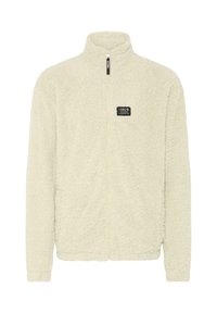 Fleece-Jacke in cremiger Farbe mit hohem Kragen, durchgehendem Reißverschluss und strukturierten Oberflächen. Enthält ein kleines Markenlabel auf der Brust.