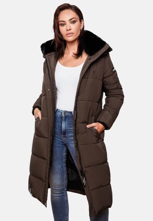 Long, padded brown coat with a faux fur collar. Features zip closure, two front pockets, and a quilted design. Worn over a white top and jeans.