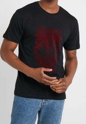 Sort t-shirt med en rød grafik af et kranium og ordet "EXTREME" ovenfor. Korte ærmer, rund hals, bomuldsstof, afslappet pasform.