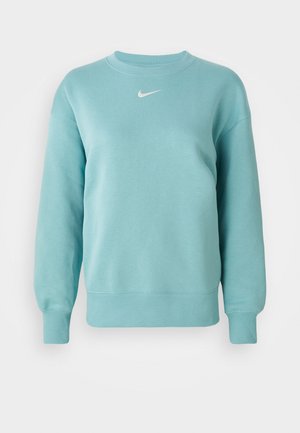 Sudadera de manga larga de cuello redondo en azul claro con puños y dobladillo acanalados, que presenta un pequeño logo de Nike en blanco en el centro del pecho.