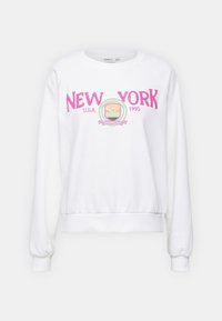 Bílá mikina s nápisem "NEW YORK" růžovými chlupatými písmeny, kulatým grafickým motivem s panorama města a žebrovaným lemem a manžetami.