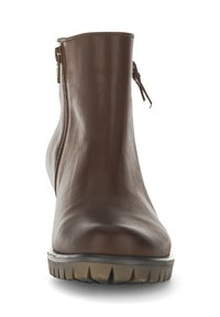 Brown leather ankle boot with a smooth finish, side zipper, and textured rubber sole featuring grooves for traction.