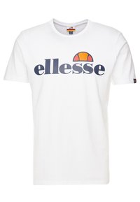 Bílá bavlněná tričko s krátkými rukávy a klasickým kulatým výstřihem. Obsahuje velké modré logo "ellesse" a grafiku oranžového slunce.