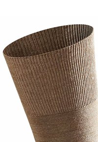 Calza a maglia al ginocchio di colore marrone chiaro, con texture a coste nella parte superiore e una sezione inferiore più liscia, con una transizione senza giunture tra i materiali.