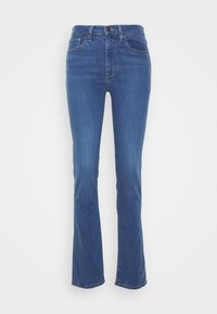 Jeans escuros ajustados, de cintura alta, com um desbotamento subtil e design tradicional de cinco bolsos. O material parece denim com uma textura suave.