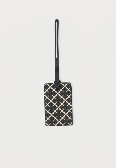 Μαύρη και μπεζ ορθογώνια ετικέτα αποσκευών με λεπτό μαύρο ρυθμιζόμενο λουράκι σε λευκό φόντο.