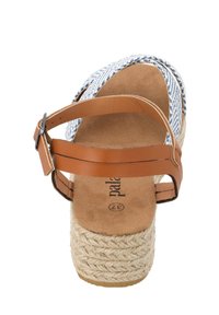 Espadrille-Sandale mit einem braunen Lederknöchelriemen, einem gewobenen Obermaterial in Blau-Weiß-Muster und einer strukturierten Juteflatform.