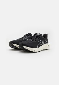 Black running shoes with a textured upper, featuring white accents, round toe, and cushioned white midsole, ideal for athletic use.