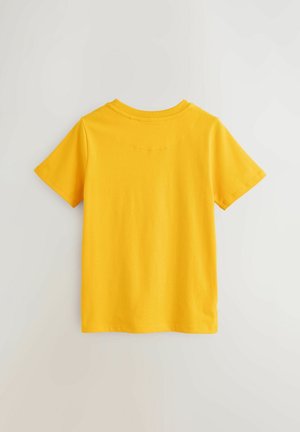 T-shirt di cotone giallo con maniche corte, scollo rotondo e tessuto morbido. La vista posteriore mostra un design semplice e senza interruzioni.