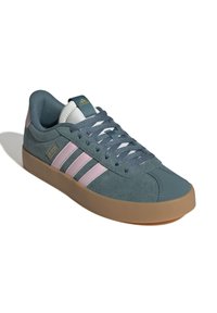 Blå mockasinsneaker med rosa tre ränder, gummisula, vadderad krage och texturerad tunga. Har snörningsdesign och logotypdetalj.