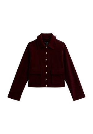 Burgundy cropped jacket with a collared neckline, gold buttons, and two front flap pockets. Made of soft fabric with a smooth texture.