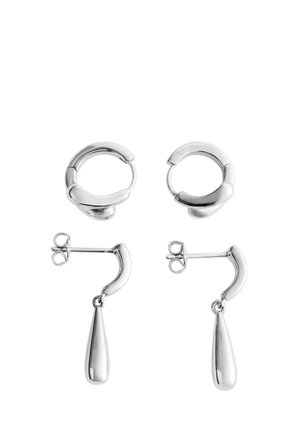 Deux paires de boucles d’oreilles en argent : une paire de créoles épaisses et lisses, et une paire de petites puces avec des barres courbées et des pendentifs goutte.