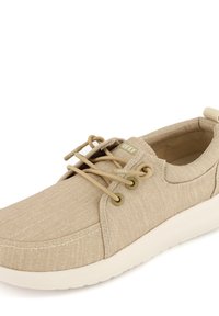 Beige Canvas-Schuh mit runder Zehenpartie, harmonischer Naht und elastischen Schnürsenkeln. Verfügt über eine weiche Innensohle und eine weiße Gummisohle. "REEF"-Logo an der Seite.