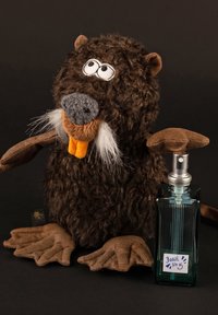 Plush brown beaver toy with round eyes, orange teeth, white whiskers, and brown paws beside green glass perfume bottle labeled "Beast No 5."