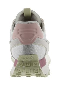 Dual-tone sneaker featuring a textured pink heel cap, reflective silver accents, and a speckled green sole. Lightweight and cushioned design.