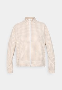Beige and white gingham zip-up jacket with high collar, long sleeves, elastic cuffs, and front pockets on a plain background.