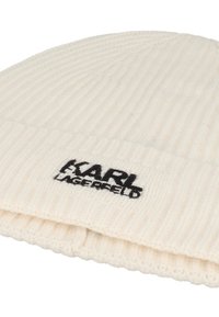 Cream ribbed knit beanie hat featuring a black embroidered logo "KARL LAGERFELD" on the cuff. Soft texture and snug fit.