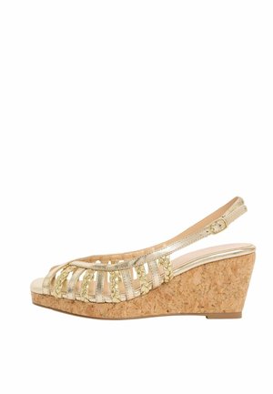 Gold strappy wedge sandal with braided accents, cork sole, open toe, and adjustable ankle buckle strap.
