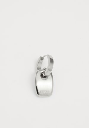 Silver metal keychain with a smooth, rounded rectangular tag engraved with "GUESS." Features a sturdy loop for attachment.