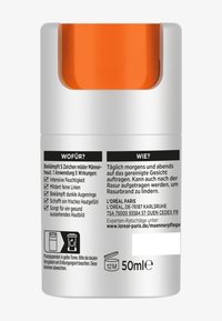 Moisturizer bottle with a white body and orange top. Features text on the label in black, detailing usage and benefits, with icons. 50ml capacity.
