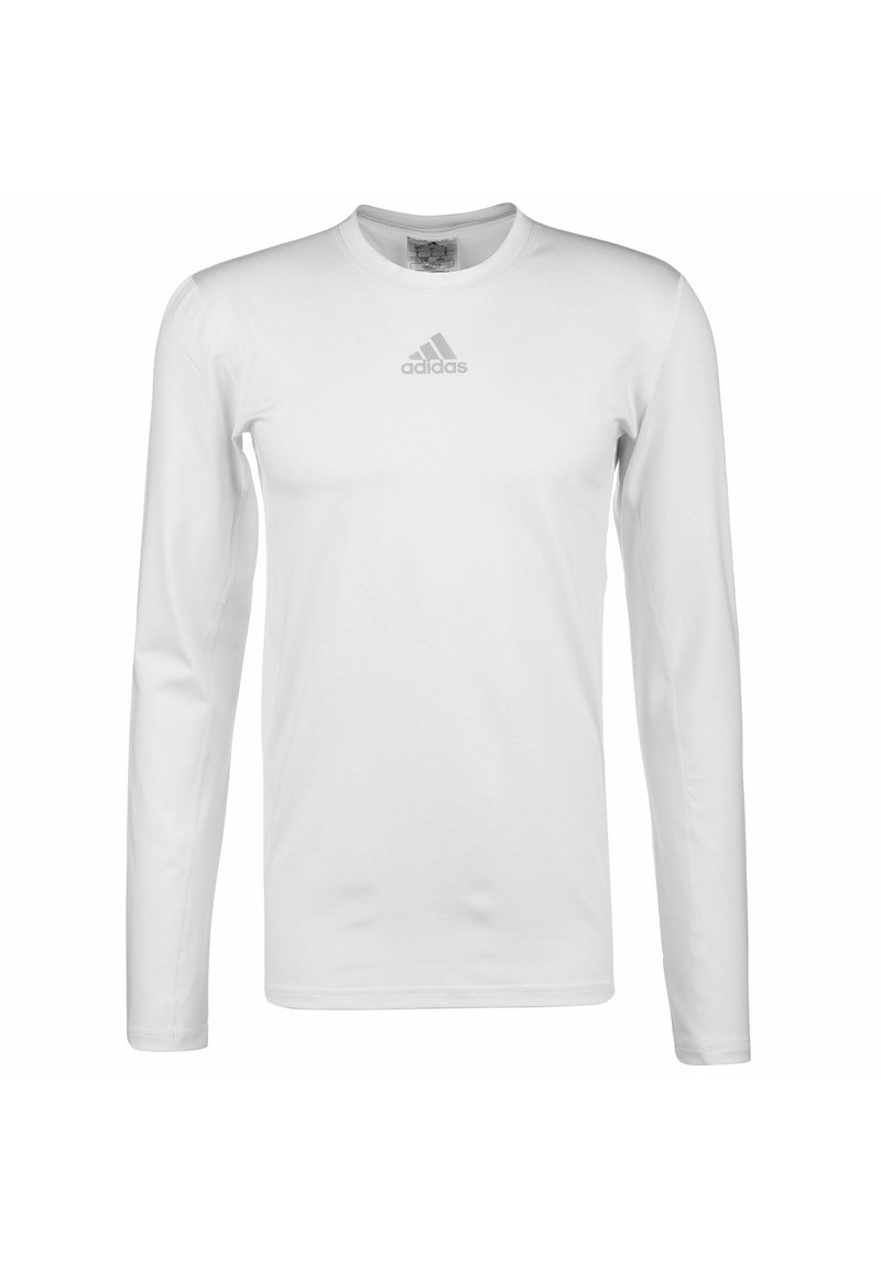 T-shirt à manches longues blanc en tissu lisse, avec un col rond et un logo Adidas gris subtil sur la poitrine.