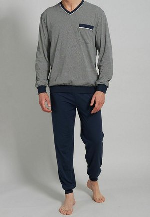Navy en gestreepte langekleurige top met V-hals en zak; gecombineerd met effen navy tapered broek. Zachte stof, relaxte fit, elastische manchetten.
