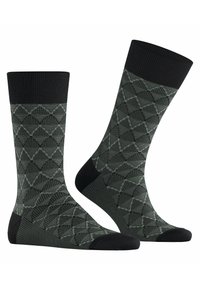 Grüne Socken mit einem Rautenmuster, schwarzem Rippbund und -zehen. Hergestellt aus einer Mischung aus weichen, dehnbaren Materialien für zusätzlichen Komfort.