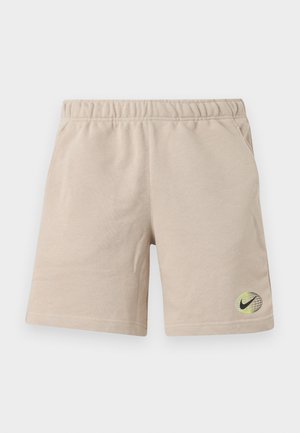 Beežid vabaajashortsid elastse vöökohaga, küljetaskud ning vasakul jalal väike must ja neoonrohelise Nike maakera logo.