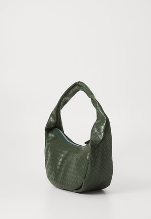 Green woven leather bag with a curved handle and zip closure. Features a textured, patterned surface and a soft, slouchy shape.