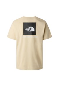 Béžové tričko s černým čtvercovým logem s nápisem "THE NORTH FACE" a bílým textem pod ním říkajícím "NEVER STOP EXPLORING" na zadní straně.