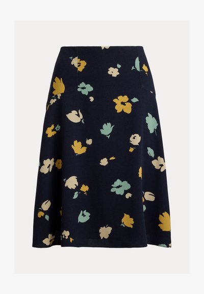 Jupe trapèze bleu marine avec des motifs floraux jaunes, beiges et verts clairs dispersés sur le tissu.