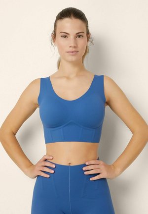 Reggiseno sportivo blu con spalline larghe, scollatura arrotondata e design senza cuciture. Materiale morbido ed elastico con leggera imbottitura.