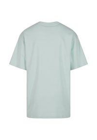 T-shirt uni bleu clair à manches courtes, vu de dos avec un col rond et une coupe ample.