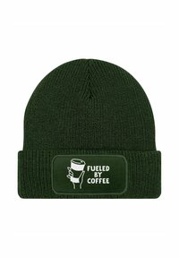 Dark green knit beanie with a folded cuff featuring a rectangular patch. The patch has white text and an illustration of a coffee cup.