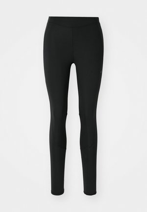 Svart leggings laget av elastisk stoff, med en jevn tekstur, tettsittende design og subtil sømdetaljering langs beina.