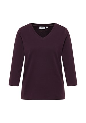 Haut à manches longues en V en violet foncé. Fabriqué dans un tissu doux avec une coupe décontractée. Aucuns motifs visibles ni détails matériels.
