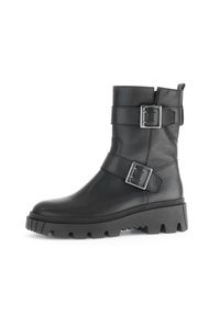 Black leather ankle boot with two adjustable silver buckles, a textured surface, and a thick, rugged sole with a pronounced tread.