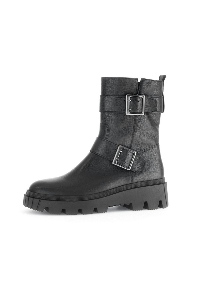Black leather ankle boot with two adjustable silver buckles, a textured surface, and a thick, rugged sole with a pronounced tread.