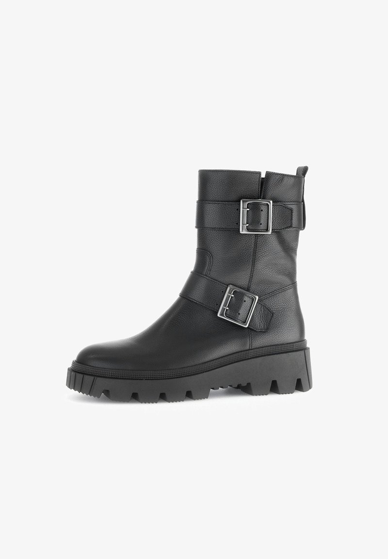 Black leather ankle boot with two adjustable silver buckles, a textured surface, and a thick, rugged sole with a pronounced tread.