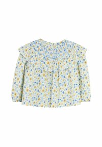 Gėlių bluzonė su geltonomis ir mėlynomis gėlėmis ant šviesiai mėlyno fono. Sukurta su frill apykakle, raukšlėtu nugara ir ilgomis rankovėmis.