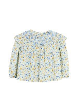 Blumige Bluse mit gelben und blauen Blumen auf einem hellblauen Hintergrund. Sie hat einen Rüschenkragen und einen gerafften Rücken sowie lange Ärmel.