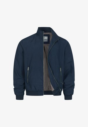 Chaqueta azul marino con cremallera, cuello de pie, dos bolsillos laterales con cremallera, puños y dobladillo acanalados, parcialmente abierta para mostrar el forro interior gris.