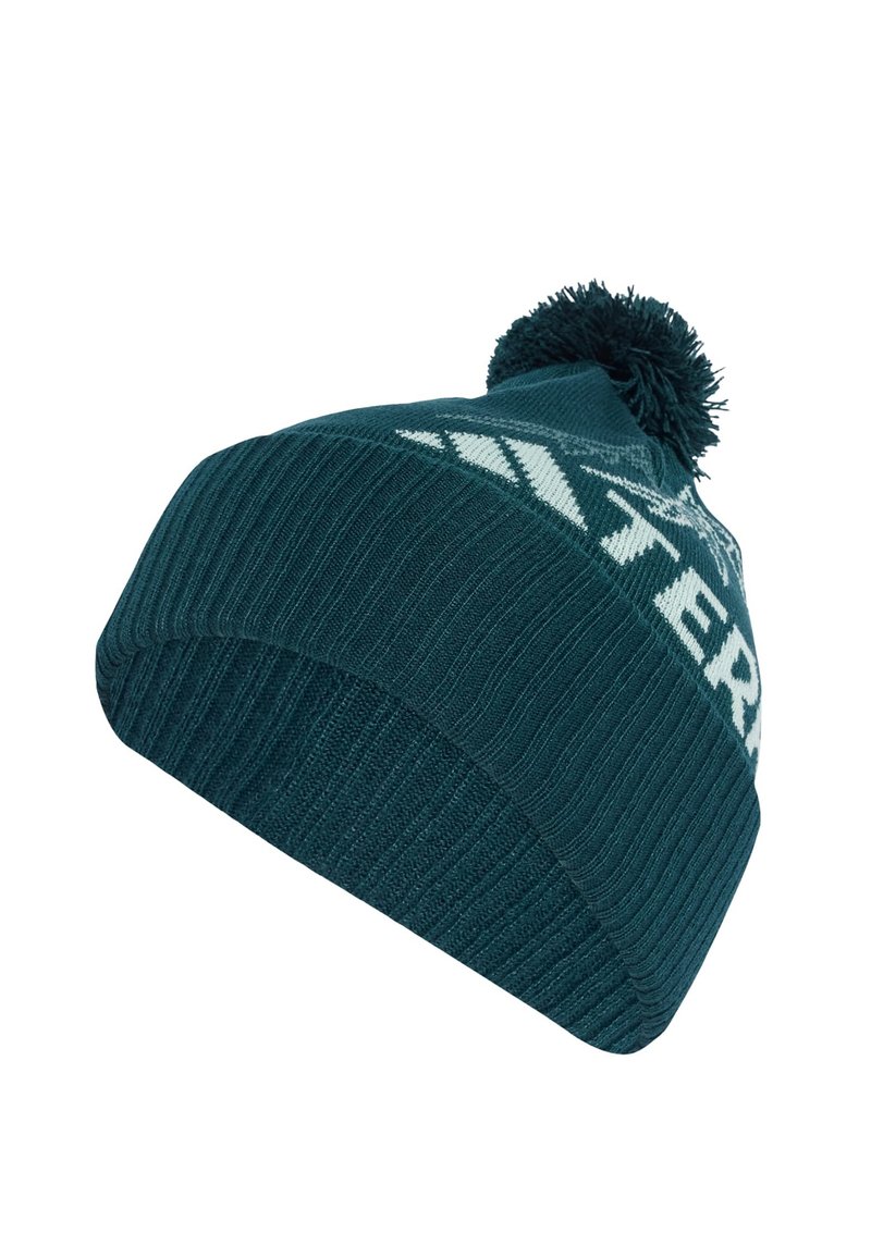Caciula din lână teal, cu un design cu nervuri, având un model grafic alb și un pompon în vârf. Textură moale și ajustare confortabilă.