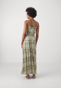 Maxi dress with spaghetti straps, featuring an olive green and cream tie-dye pattern, made of soft, lightweight fabric with a relaxed fit.