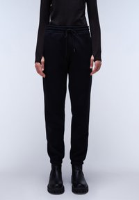 Schwarze Jogginghose aus weichem Material, mit einem elastischen Bund und Kordelzug sowie gerippten Bündchen an den Knöcheln.