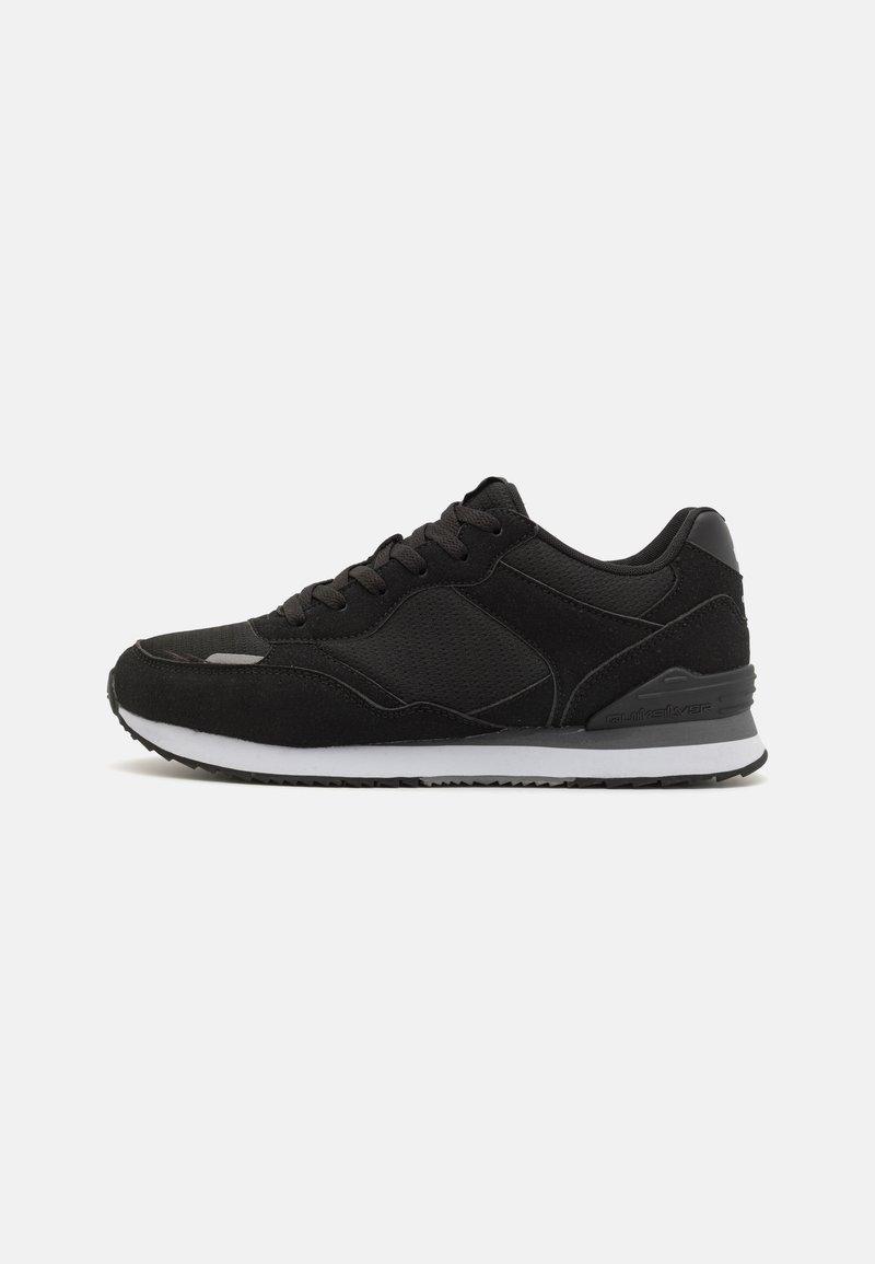 Black athletic sneakers featuring a textured upper, padded collar, and white midsole with a black rubber outsole.