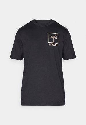 Black cotton t-shirt with short sleeves, featuring a beige graphic design of an umbrella and a leaf in a square, labeled "ADIDAS."