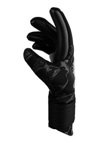 Gants noirs en tissu texturé avec des bouts des doigts moulés et brillants. Accentués par un motif subtil et maintenus par une sangle noire au poignet.